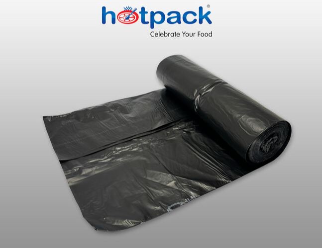 Roll of 55 gallon garbage bags stacked black large trash liners